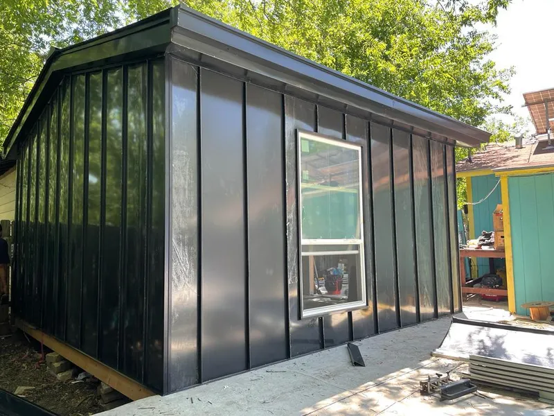 Black standing seam metal wall panels for Roof Inspection in Denton