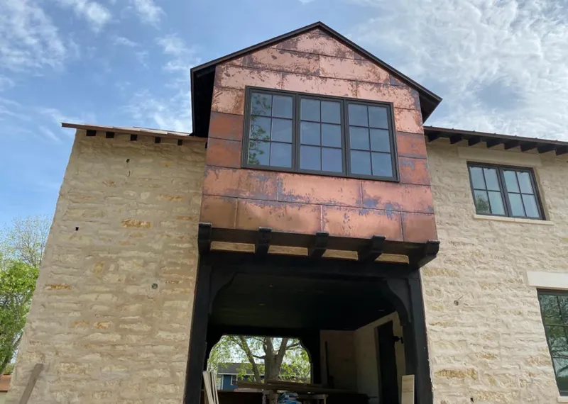 Copper metal panel facade on a stone building for Metal Roof Coating in Denton